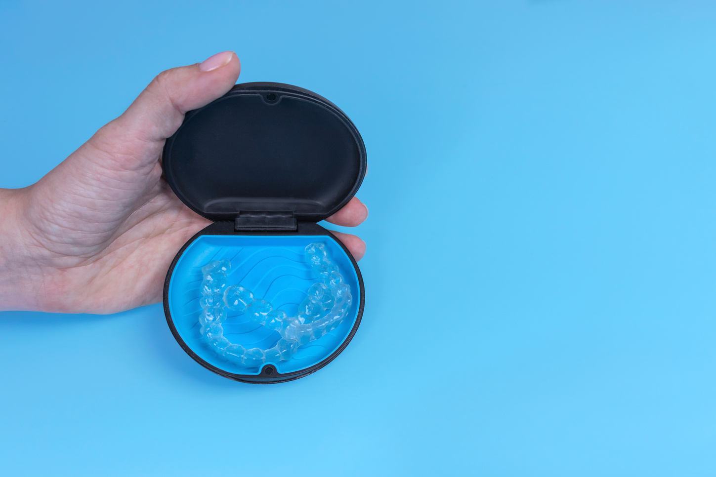Invisible transparent aligners invisalign in container blue back